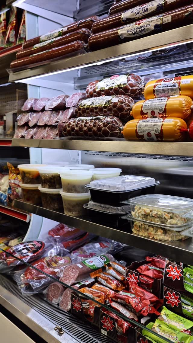 Meat and prepared products stocked in the market case.